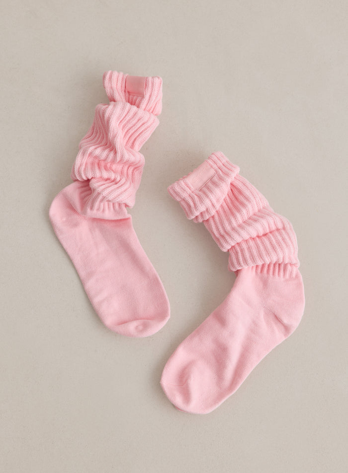Two pink Ballerina Slouch Socks from aim'n featuring a ribbed, slouchy texture.