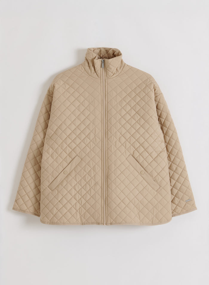 Beige aim'n Oversized Quilted Jacket with diamond quilting, a stand collar, and front zip shown in a flatlay.