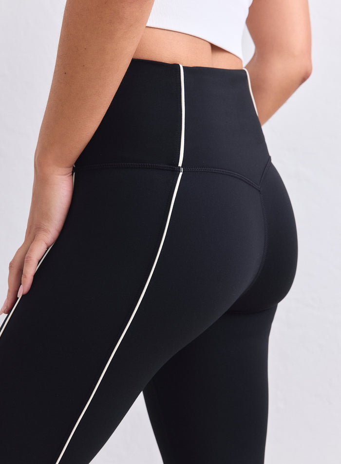 Black high-waisted Sense Contrast Tights with white piping and a second skin feel from aim'n. [XS-165cm]