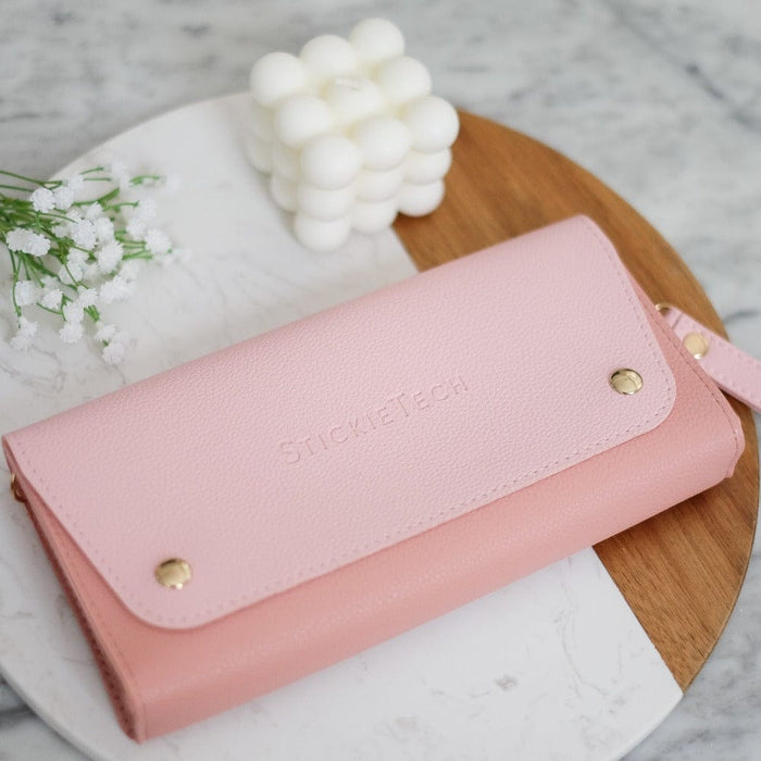 Blush pink Nintendo Switch travel pouch with gold hardware and wrist strap