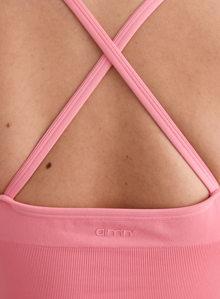 Close-up of the back of the Blush Shape Seamless Cross Back Bralette with a cross-over strap design and tonal aim'n logo [L-174cm]