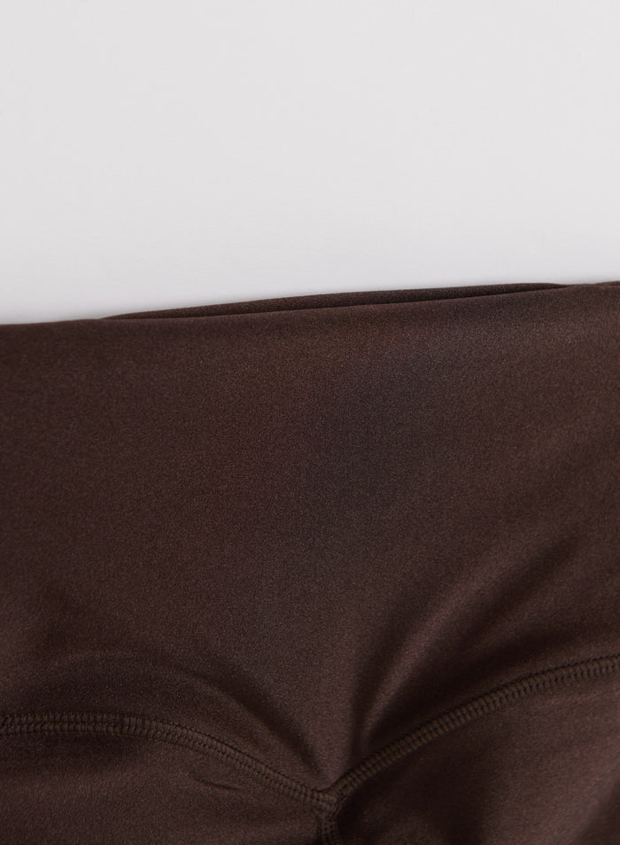 Close-up of the high waistband on these chocolate brown shimmer tights with a subtle sheen by aim'n.