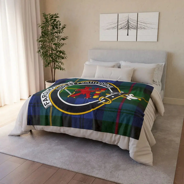Farquharson clan crest throw blanket draped over sofa — full-colour tartan print, white reverse