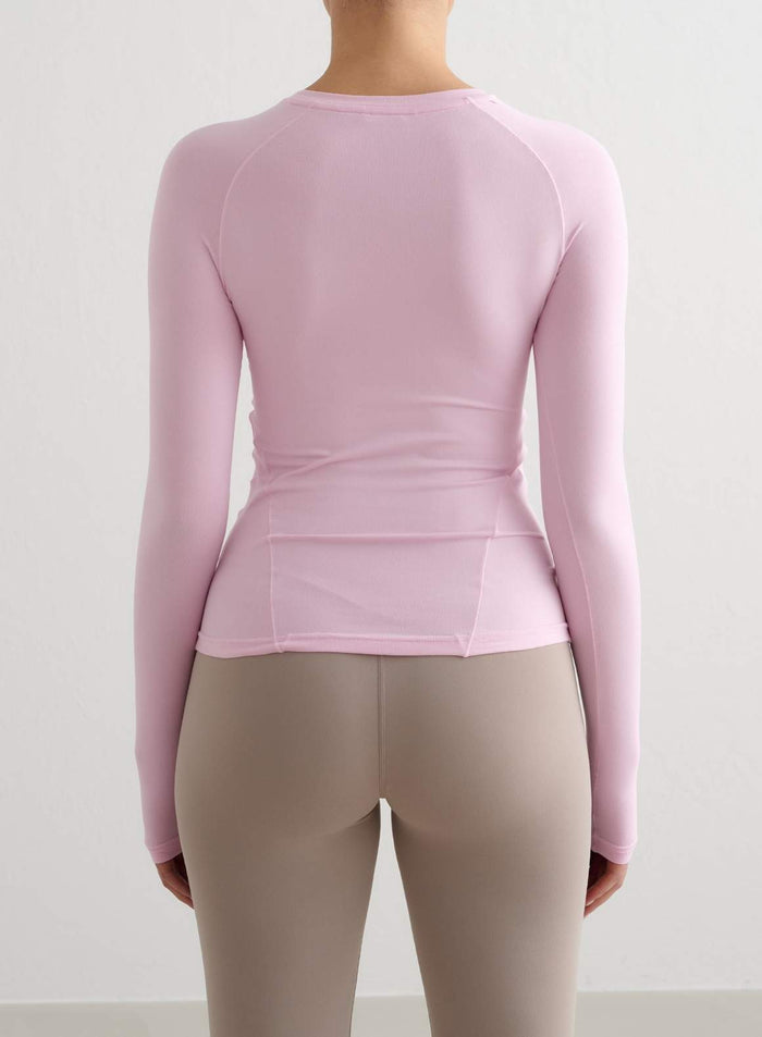 Cotton Candy pink aim'n Soft Basic Long Sleeve with raglan sleeves and a second skin fit, back view.