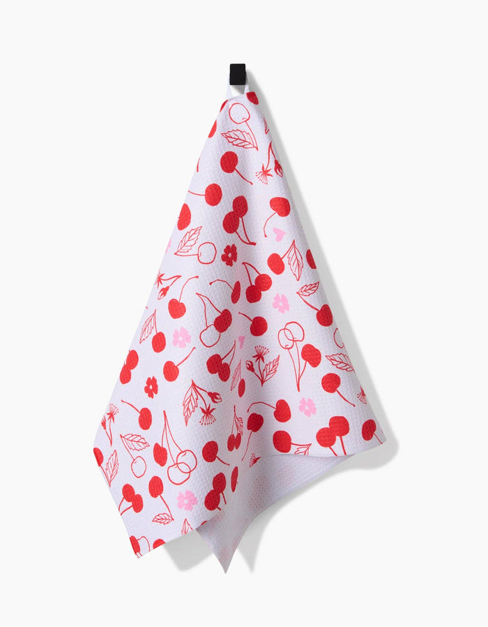 towel with cherry pattern hanging against white background