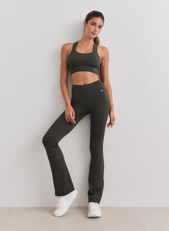 Model in dark ivy ribbed seamless flare tights and matching sports bra from aim'n. [S-178cm]