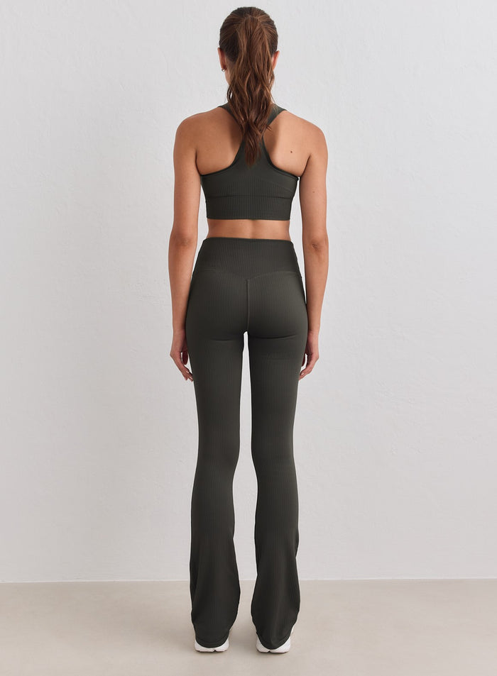 Dark ivy ribbed seamless flare tights with a high waist by aim'n shown from behind. [S-178cm]