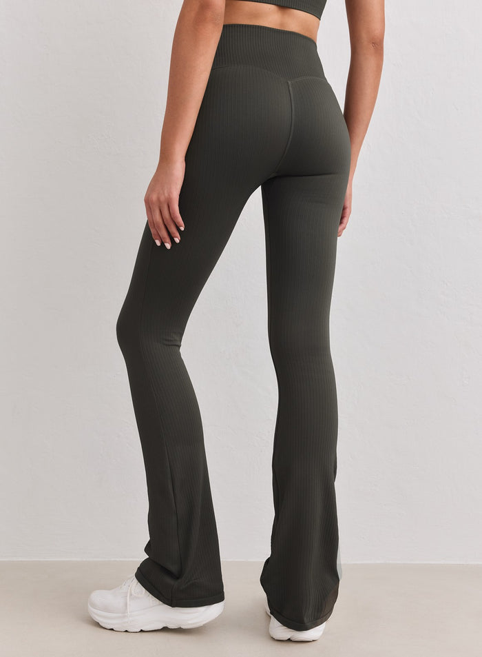 Rear view of dark ivy aim'n ribbed seamless flare tights with a high waistband. [S-178cm]