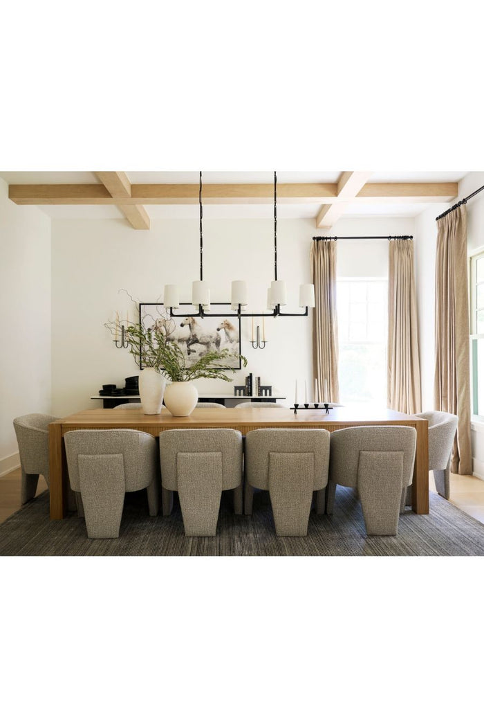 Modern dining room with a long wooden table and gray chairs and the Elm double sconce on the back wall.