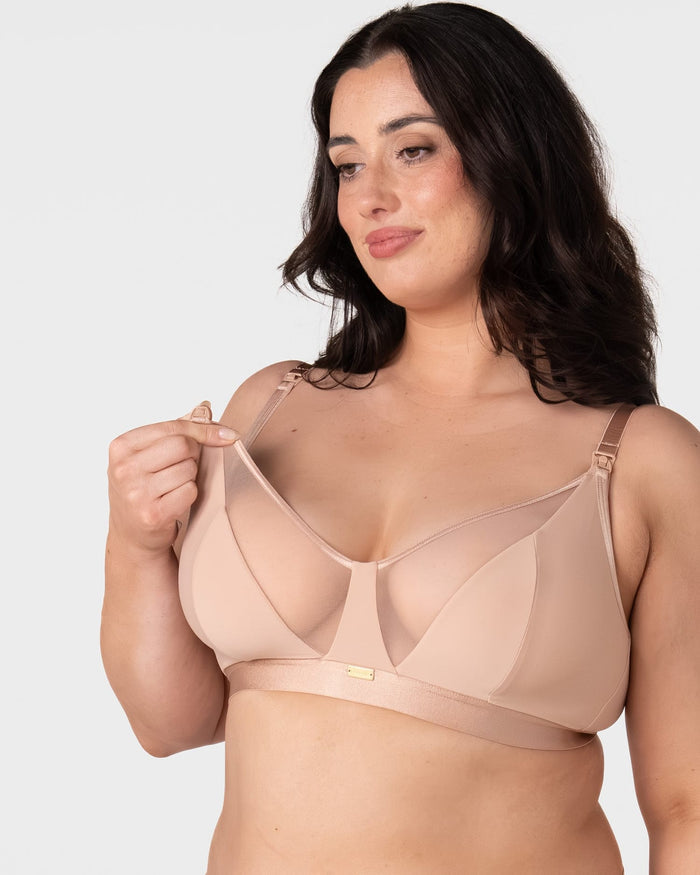 Model demonstrating one-handed nursing clip release on the Hotmilk Flawless Plunge Wirefree Nursing Bra in Cashmere – showing easy breastfeeding access via side-sling design