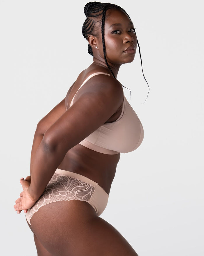 Side profile of model wearing the Hotmilk Flawless Plunge Wirefree Nursing Bra in Cashmere with matching lace briefs – showing sleek cup silhouette and smooth wirefree support