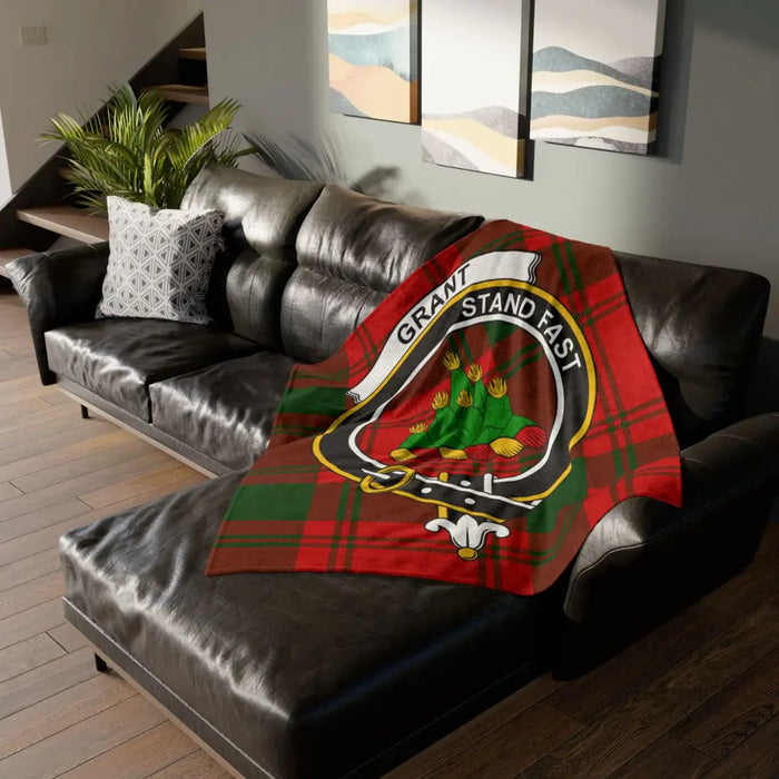 Grant clan crest throw blanket on sofa — 50x60 polyester, Stand Fast tartan heraldic design