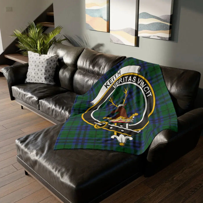 Keith printed throw blanket on sofa with crest