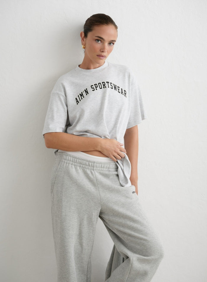 Oversized light grey melange varsity t-shirt featuring a dark aim'n logo print and crew neck. [XS-165cm]