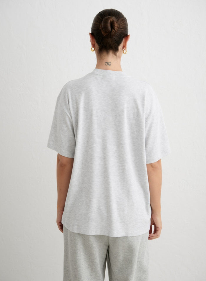 Back view of an oversized light grey melange boyfriend t-shirt by aim'n in soft organic cotton. [xs-165cm]