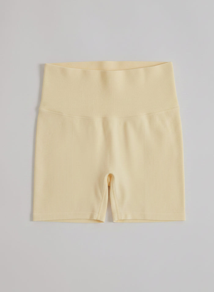 Mellow yellow aim'n Shape Seamless Hotpants featuring a high ribbed waistband shown in a flatlay view.