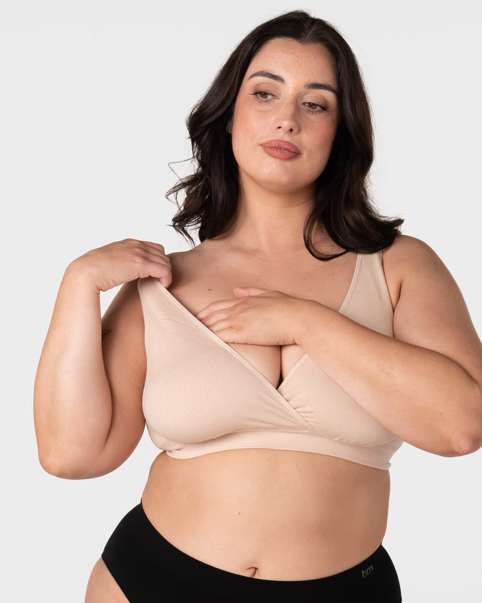 Model demonstrating pull-aside nursing access on the Hotmilk My Comfort Nursing Bra in Oat – showing easy side-access breastfeeding functionality