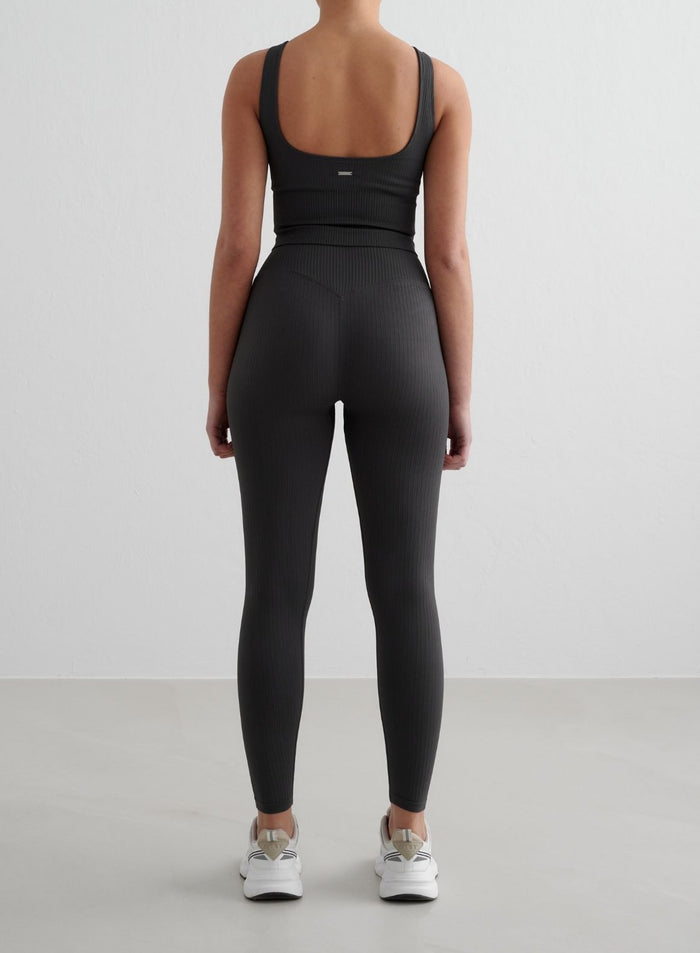 Dark grey aim'n Ribbed Seamless Tall Tights with a second skin feel, shown from a back view.