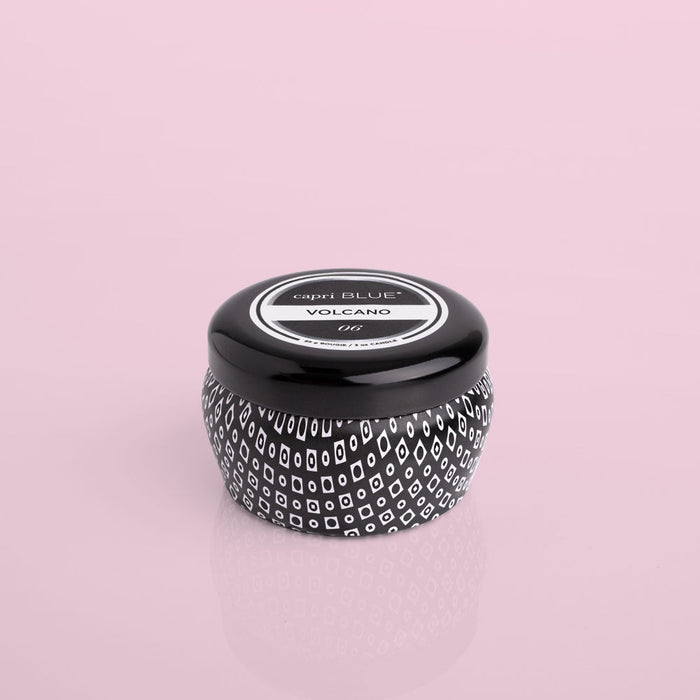 A black mini tin with a textured design, featuring the 'Volcano' fragrance branding on the top.