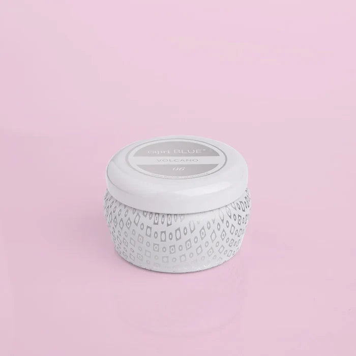 A white mini tin with a textured surface and a label that includes the brand name and 'Volcano Signature' fragrance line.