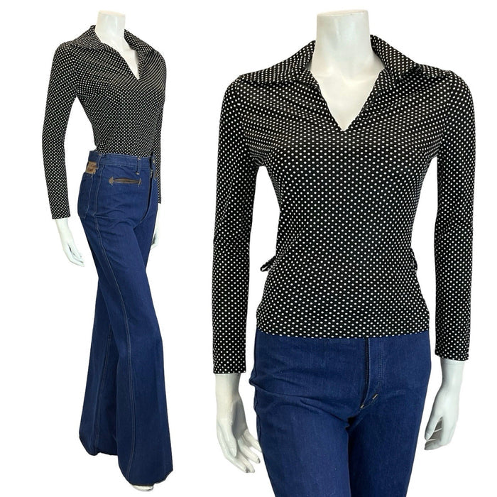 mannequin wears blue flared jeans and a polka dot black and white long sleeve wing collar top